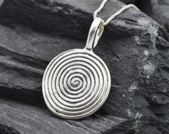May include: Silver pendant necklace with a spiral design. The pendant is round and has a textured surface.