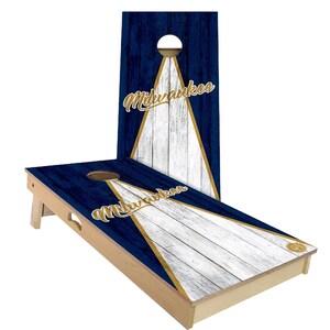 May include: A wooden cornhole set with a blue and white woodgrain design. The boards feature a gold triangle with the word "Milwaukee" in gold lettering.