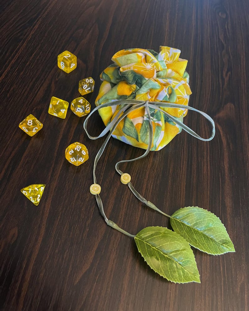 closed bag with a scatering of yellow dice around it