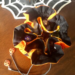 open bag with a set of dice in each of the 6 pockets