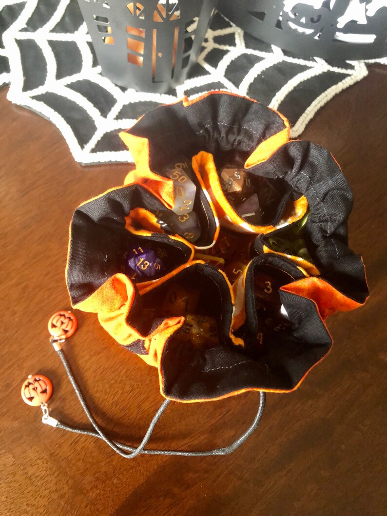 open bag with a set of dice in each of the 6 pockets