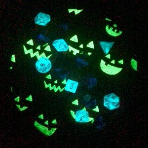 inside of the bag, layed flat. the fabric glows with jack-o-lantern faces
