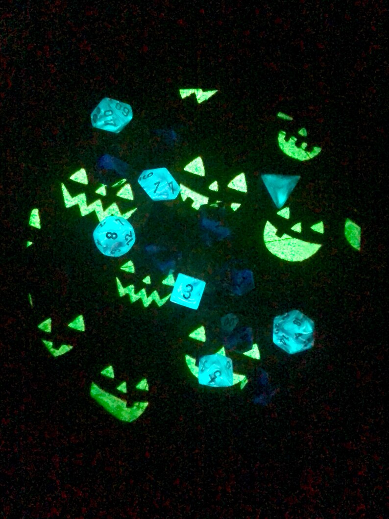 inside of the bag, layed flat. the fabric glows with jack-o-lantern faces