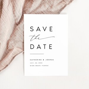 May include: A white save the date card with black text that reads "Save the Date" in a modern font. The names "Catherine & Joshua" are listed below, followed by the date "July 14, 2023" and the location "Miami Beach, Florida".