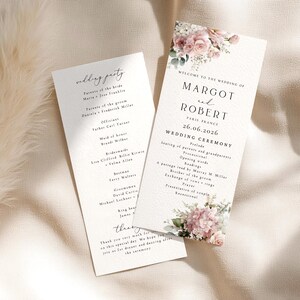 May include: Two white wedding ceremony programmes featuring floral illustrations of pink roses and greenery. The text reads Welcome to the wedding of Margot and Robert, Paris, France, 26.06.2026, Wedding Ceremony, and lists the wedding party members.