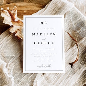 May include: A white wedding invitation with black text. The invitation reads "M|G Together with their families Madelyn and George Request the pleasure of your company at their wedding August twenty-one, twenty-twenty-two at 4 o'clock in the afternoon The Pergola and Hill South End Way London, England reception to follow"