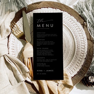 May include: A black and white wedding menu card with the words "the MENU" in a handwritten font. The menu includes appetizers, starters, main course, desserts, coffee and tea, and after-dinner liqueurs. The names Nina and James are at the bottom of the card with the date 07.12.2022.