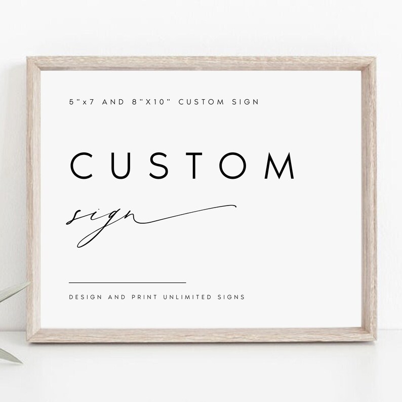 May include: A white framed sign with black text that reads "5"x7" AND 8"x10" CUSTOM SIGN" and "CUSTOM sign" with a handwritten flourish. The text "DESIGN AND PRINT UNLIMITED SIGNS" is also included.