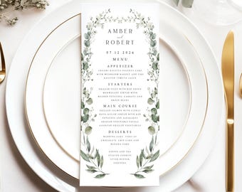 May include: A wedding menu card with a green leafy border. The card features the names Amber and Robert, the date 07 12 2026, and a list of appetizers, starters, main course, desserts, coffee and tea, and after dinner liquors.