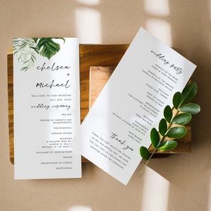May include: Wedding ceremony programme with a tropical leaf design. The programme includes the names Chelsea and Michael, the wedding date, and the order of events. The wedding party is listed on the right side of the programme.