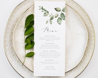 May include: A wedding menu card with a green leafy design. The menu includes appetizers, starters, main course, desserts, coffee and tea, and after dinner liquors.
