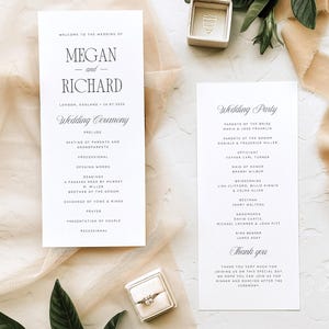 May include: Wedding stationery set with a ceremony program, wedding party details, and a ring box. The program lists the ceremony order, while the second card details the wedding party. A ring is displayed in a small box.