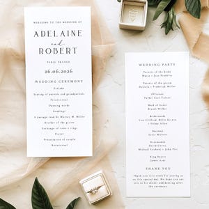 May include: Wedding stationery set featuring a wedding program, a wedding party list, and a ring box. The program lists the ceremony details, date, and names. The ring box is open, displaying a diamond ring.