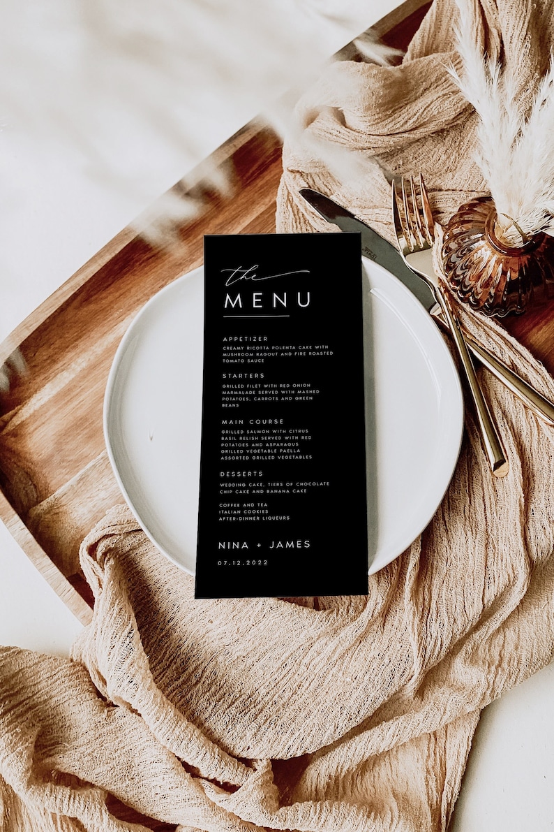 May include: A black and white wedding menu card with a handwritten font. The menu includes appetizers, starters, main course, desserts, coffee and tea, Italian cookies, and after-dinner liqueurs. The card also includes the names Nina and James and the date 07.12.2022.