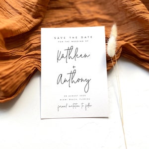 May include: Save the date card with white background and black text. The card says "Save the Date for the Wedding of Kathleen + Anthony 28 August 2026 Miami Beach, Florida formal invitation to follow"