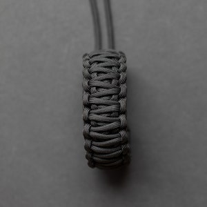 May include: A black paracord bracelet with a braided design.