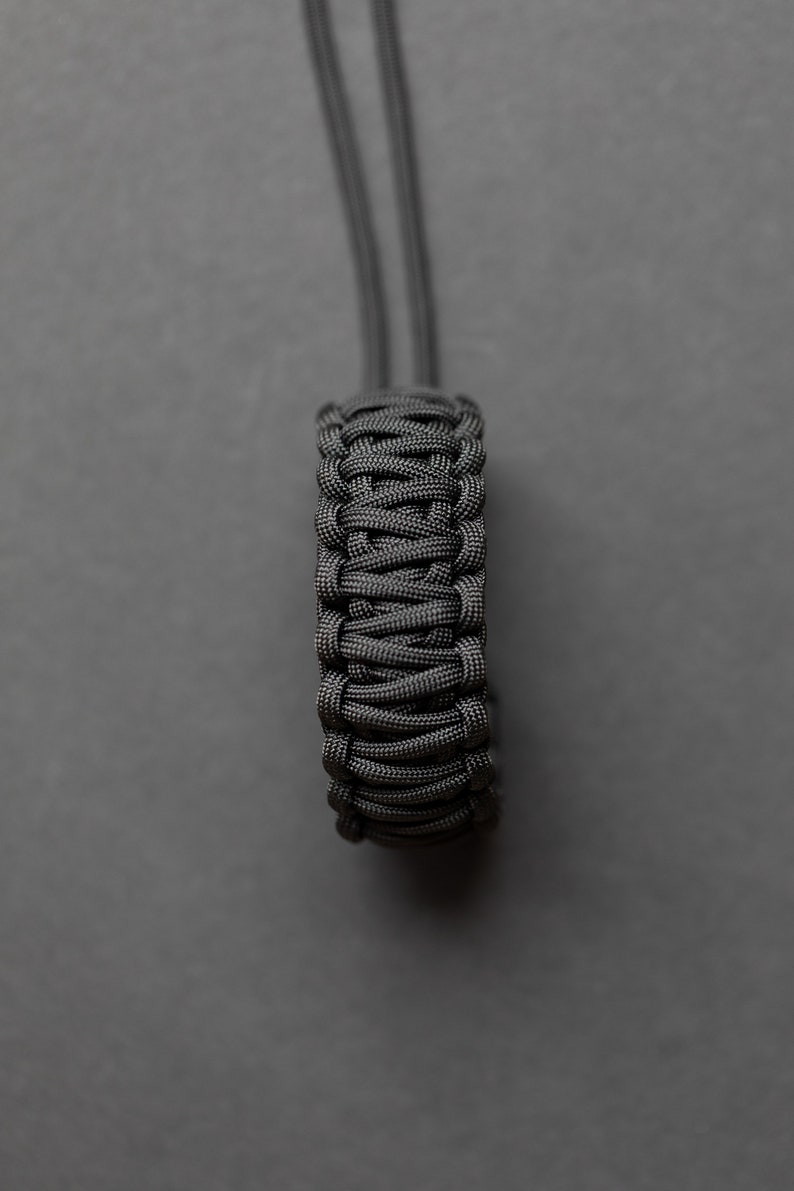 May include: A black paracord bracelet with a braided design.