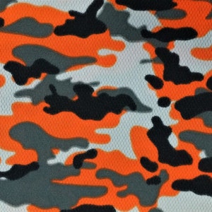 May include: Orange, black, and gray camouflage pattern fabric with a mesh texture.