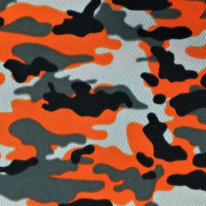 May include: Orange, black, and gray camouflage pattern fabric with a mesh texture.