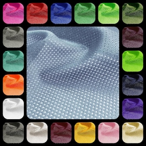 May include: A close-up of a light blue fabric with a textured, dotted pattern. The fabric is shown in a variety of colors, including pink, red, blue, green, gray, orange, white, black, purple, yellow, and brown.