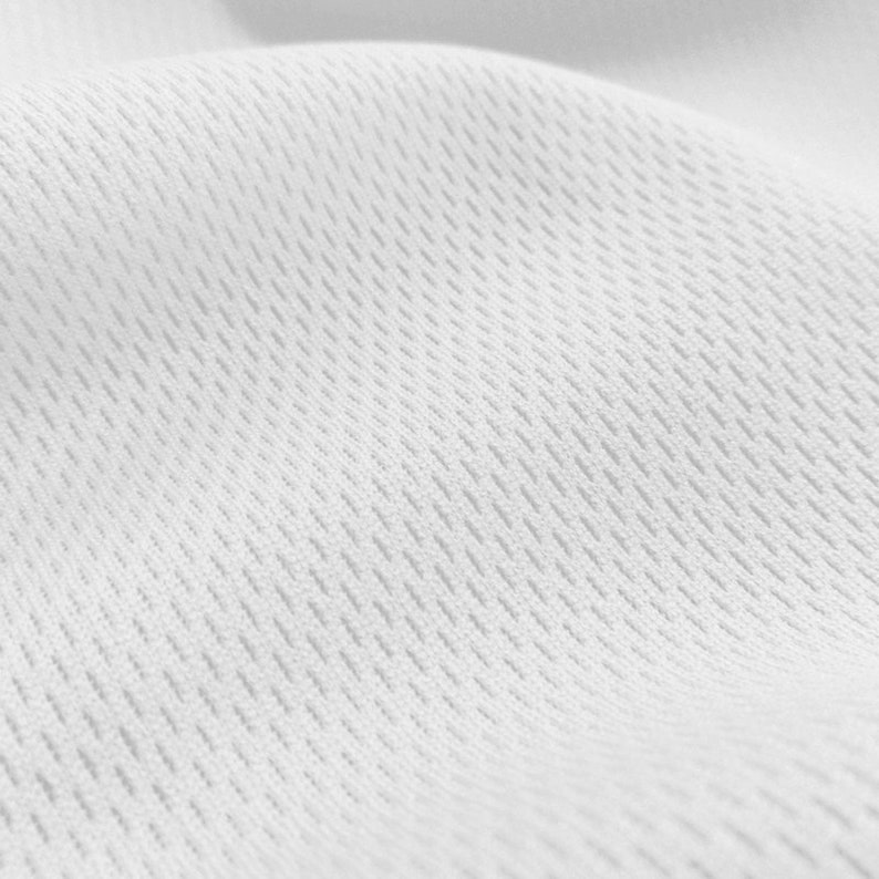 May include: White fabric with a textured, woven pattern. The fabric is smooth and has a slight sheen.