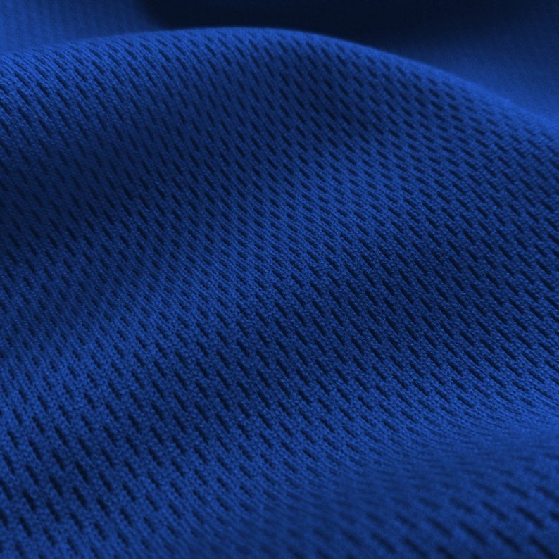 May include: Close-up of a blue fabric with a textured, woven pattern. The fabric has a slightly rippled surface.