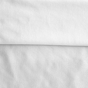May include: Two pieces of white fabric, one smooth and one textured, are layered on top of each other. The smooth fabric is on top and the textured fabric is on the bottom.