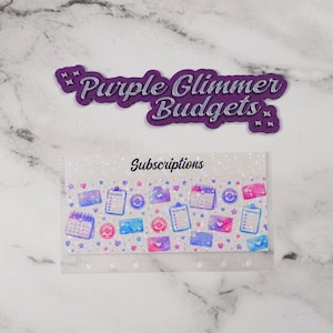 May include: A rectangular cash envelope labeled Subscriptions with a holographic finish featuring icons of calendars, clipboards, envelopes, and credit cards in shades of blue and pink, accompanied by a purple die-cut sign reading Purple Glimmer Budgets.