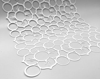 May include: A white, laser-cut decorative panel featuring a repeating floral pattern. The design incorporates circles and petal-like shapes, creating an intricate, openwork texture. The panel is slightly curved, suggesting a three-dimensional form.
