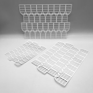 May include: White, laser-cut decorative panels with a repeating arched window design. The panels are arranged in stacks and flat layouts, showcasing the intricate, openwork pattern. The design is suitable for craft projects or decorative applications.