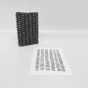 May include: A black and gray rectangular stamp with a textured pattern of short, vertical lines. A matching print on white paper is also visible, showcasing the stamp's design. The stamp is likely used for creating patterned designs.