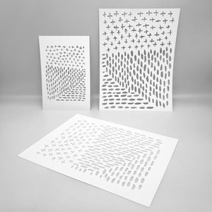May include: Three white paper cutouts with abstract designs. The cutouts feature a pattern of plus signs and oval shapes, creating a sense of depth and dimension. The designs are displayed against a neutral grey background.