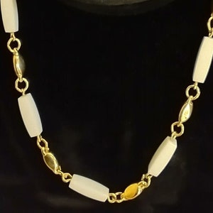Vintage necklace by TRIFARI. White enamel and lucite gold tone metal chain