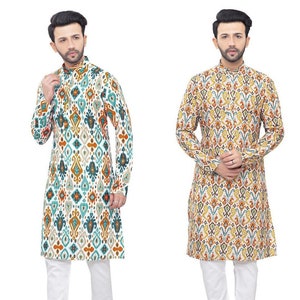 May include: Two long-sleeved shirts with a white background and a colourful geometric pattern. The shirts have a mandarin collar and a button closure. The shirts are paired with white trousers.