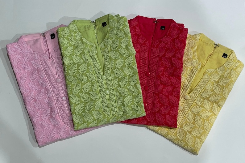 May include: Four embroidered tunics in pink, green, red, and yellow with white floral patterns. The tunics have a mandarin collar and button closure.