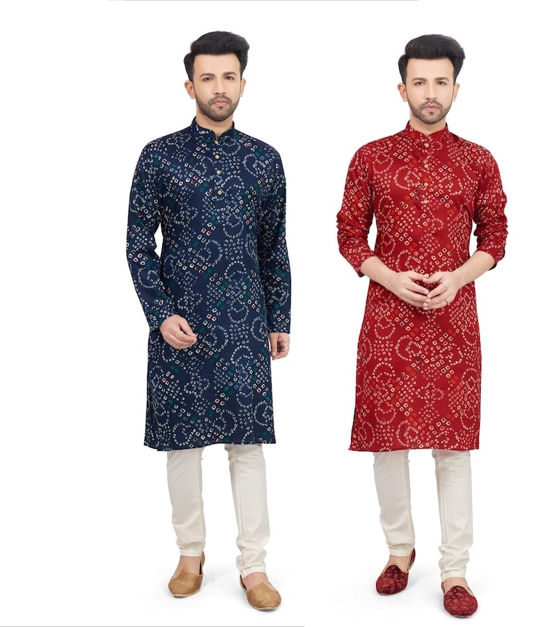 May include: Two men wearing long-sleeved shirts with a patterned design. The shirts are blue and red with white accents. The men are wearing white pants and brown and red shoes.