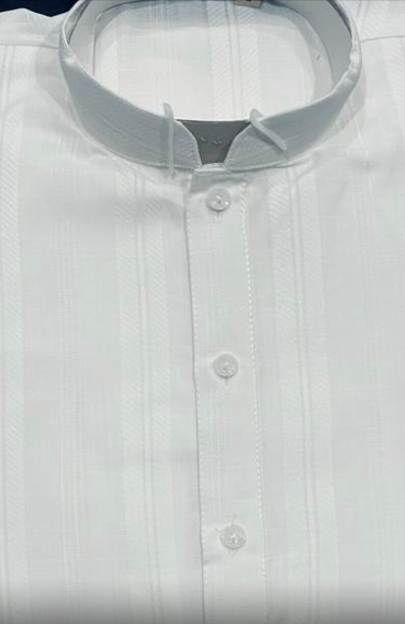May include: A white collared shirt with vertical stripes and a button-up front.