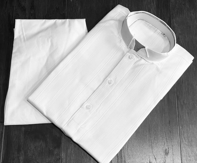 May include: A white collared shirt with a striped pattern and a white undershirt. The shirt has a mandarin collar and two buttons.