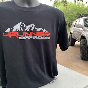 May include: Black t-shirt with a white mountain range graphic and the text "4RUNNER OFF ROAD" in red.