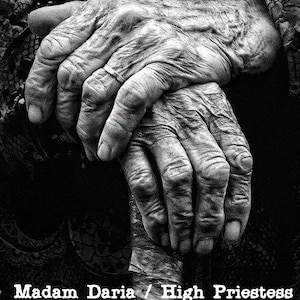 May include: Close-up black and white photo of a pair of wrinkled hands clasped together. The text "Madam Daria / High Priestess Original Romanian Witch" is at the bottom of the image.