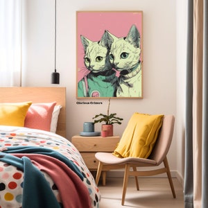 May include: A digital art print featuring two cats wearing astronaut suits. The cats are white with green and yellow accents. The background is pink with a distressed texture. The print is titled "Glorious Critters".