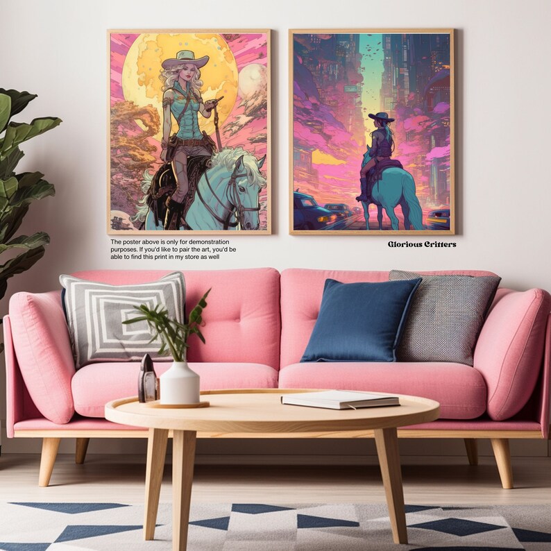 May include: Two framed posters with a pink and blue colour scheme. The posters feature a woman riding a horse in a futuristic setting. The text on the bottom of the poster reads "Glorious Critters".