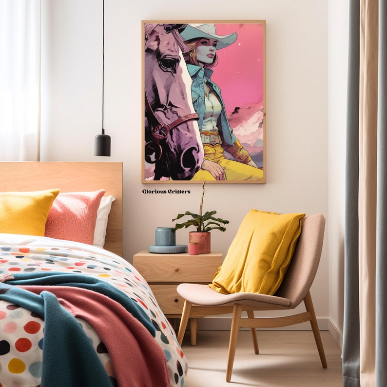 May include: A framed illustration of a woman wearing a cowboy hat and riding a horse. The woman is wearing a blue denim shirt and yellow pants. The background is a pink and blue gradient with mountains in the distance. The text "Glorious Critters" is printed below the image.