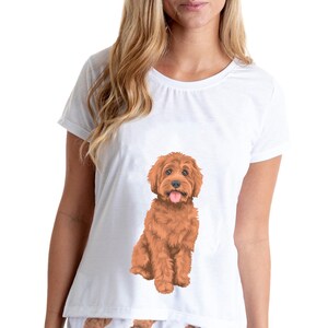 May include: White pajamas with a brown dog print. The top has a single large dog image and the shorts have a repeating pattern of smaller dogs.