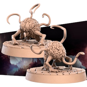 May include: Two 3D printed miniature brain-like creatures with multiple tentacles, standing on circular bases. The creatures are a light brown color and have a detailed texture.