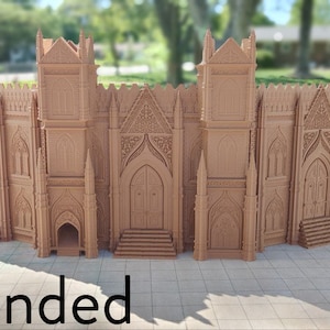 May include: A detailed, intricately designed, brown, 3D printed model of a large gothic cathedral with a tall, pointed roof and multiple arched windows. The model is set against a blurred background of green trees and a house.