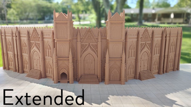 May include: A detailed, intricately designed, brown, 3D printed model of a large gothic cathedral with a tall, pointed roof and multiple arched windows. The model is set against a blurred background of green trees and a house.