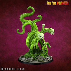 May include: A green monster figurine with tentacles, skulls, and a base of bones and a tombstone. The figurine has the text "Print Your Monsters" in the upper right corner. The artist's name, Emmanuel Lepas, is in the lower left corner.