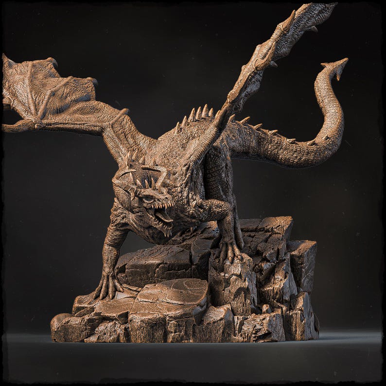 May include: A detailed bronze sculpture of a dragon with wings spread, perched on a rocky base. The dragon has a fierce expression and sharp claws.