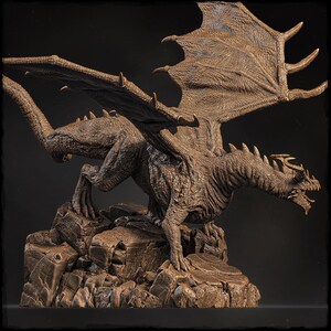 May include: A detailed bronze sculpture of a dragon with outstretched wings, perched on a rocky base. The dragon has a textured, scaly body and a fierce expression.